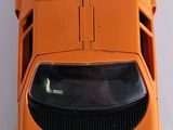 an orange toy car that is sitting on a table