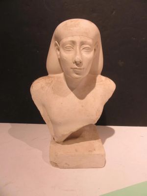 a statue of a woman that is sitting on a table
