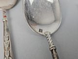 two spoons and a spoon with a handle on a table