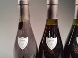 three bottles of wine sitting on a table next to each other