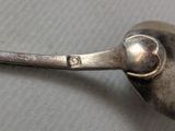 a spoon with a metal handle sitting on a table