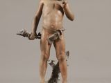 bronze statue of a boy with a dog on a pedestal
