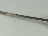 a very old sword that is laying on the table