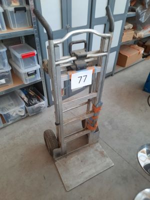a hand truck with a sign on it in a garage