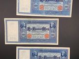 three old german bank notes on a black background