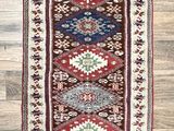 a red, blue and green rug on a wooden floor