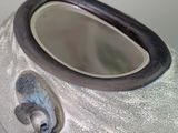 a close up of a vase with a mirror in it
