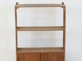 an image of a wooden shelf with two drawers and a door