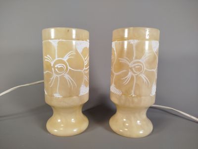 two vases that are sitting on a table