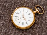 une montre de poche en or avec des chiffres romains