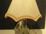 a lamp that is sitting on a table with a lamp shade on it