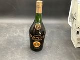 a bottle of alcohol sitting on a counter next to a toaster