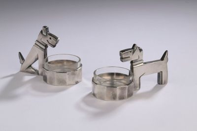 pair of silver plated dog napkin holders on a white background