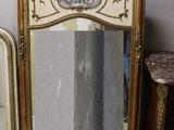 three mirrors that are sitting on a shelf next to each other