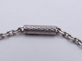 silver bracelet with a chain and a clasp on a white surface