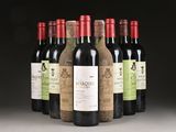 six bottles of wine are lined up in a row on a table