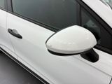 a white car with a mirror on the side of it