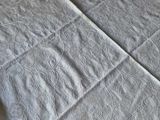 two beds that have white sheets on them on the floor