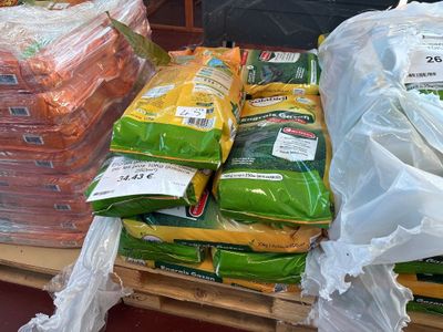 many bags of food on a pallet in the store