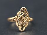 a close up of a gold ring on a black surface