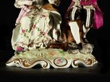 a figurine of two people sitting on a bench