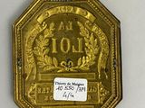 an image of a gold plate with a picture of a lion on it