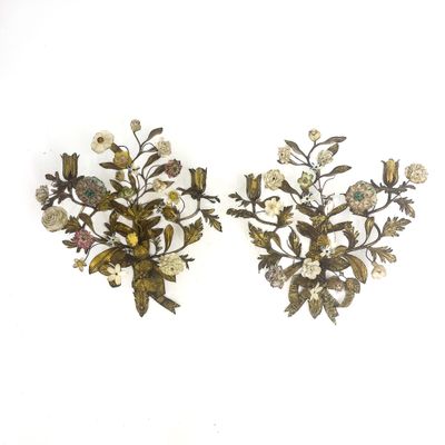 two wall sconces that have flowers and birds on them