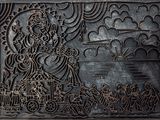 an image of a metal plaque with a picture of a woman on it