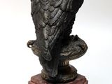 statue of an eagle sitting on a pedestal on a white background