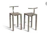 pair of metal bar stools with backrests on a white background