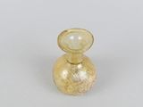 yellow glass perfume bottle with a gold decoration on the top