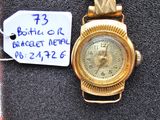 a gold wrist watch with a price tag attached to it