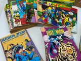 a lot of comic books on display on a table