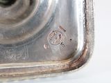 a close up of a metal object on a white surface
