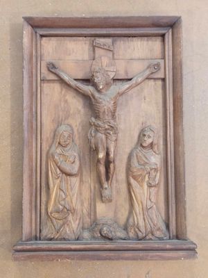 a statue of jesus on the cross on the wall