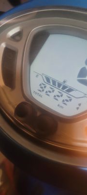 a close up of a clock on the side of a table