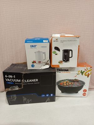several boxes of food are stacked on a table with a blender