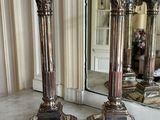 two candles that are sitting on a marble table