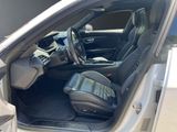 the interior of a car with the door open and the driver ' s seat down
