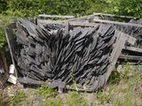 a pile of broken up wooden boards in the grass