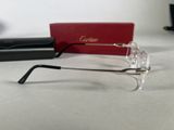 a pair of glasses sitting on a table next to a pair of glasses