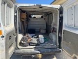 a white van that has a bunch of items in the back