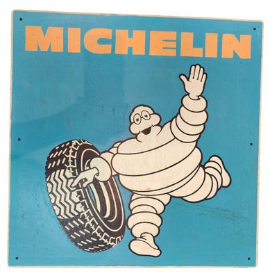 an old michel michel tire sign is hanging on a wall