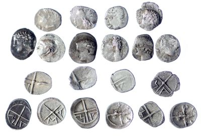 several different types of silver coins are shown on a white surface