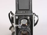 a black and white photo of a camera on a white surface