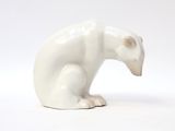 a white bear figurine sitting on a white surface