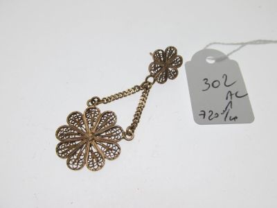 a close up of a necklace with a tag attached to it