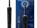 an image of a black and white electric toothbrush next to a box of toothpaste