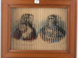 painting of two women in a wood frame on a wall