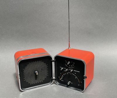 an orange and black radio sitting next to each other on top of a table